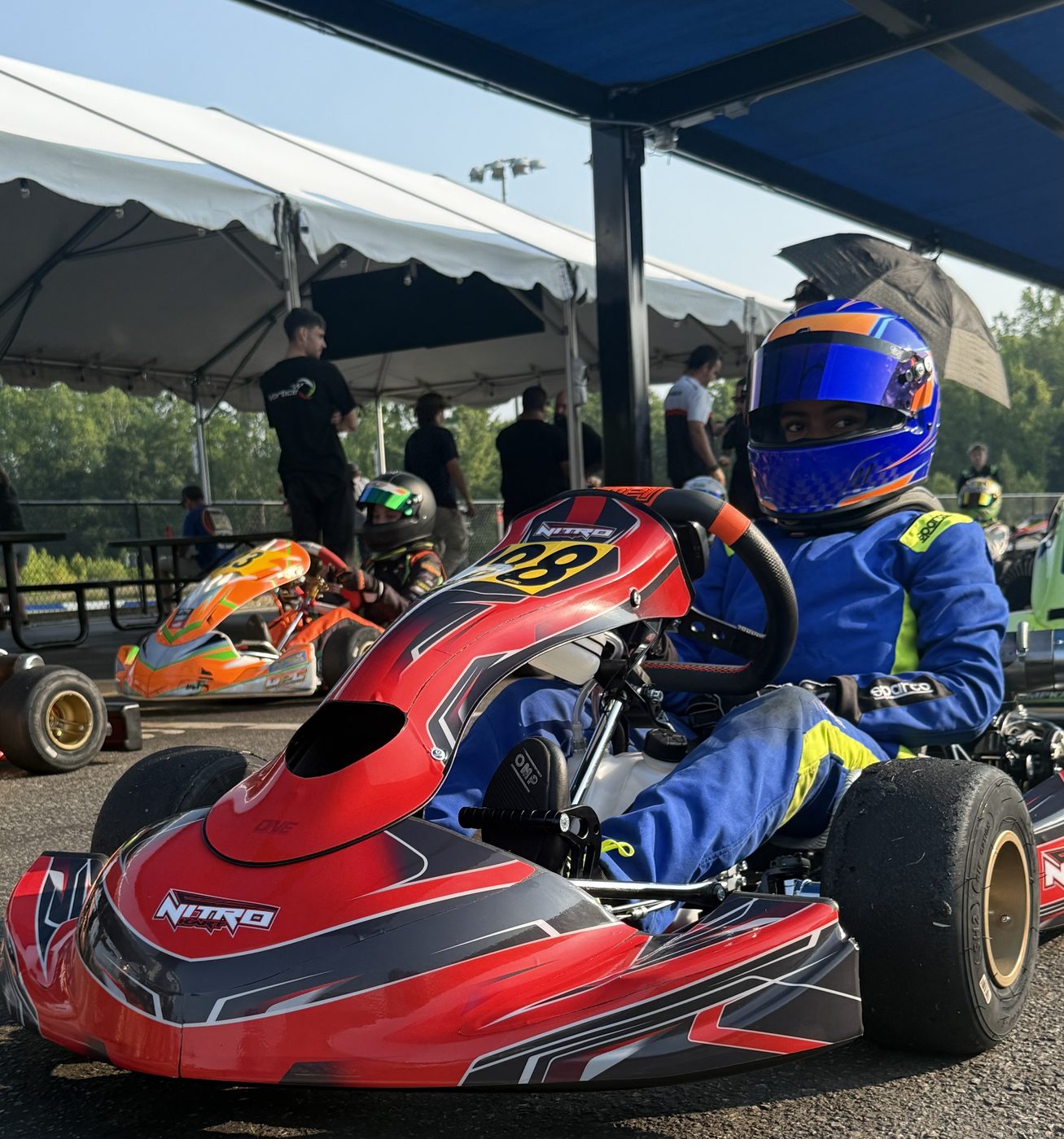 Kaz staged on the grid in the No. 8 kart, helmet on