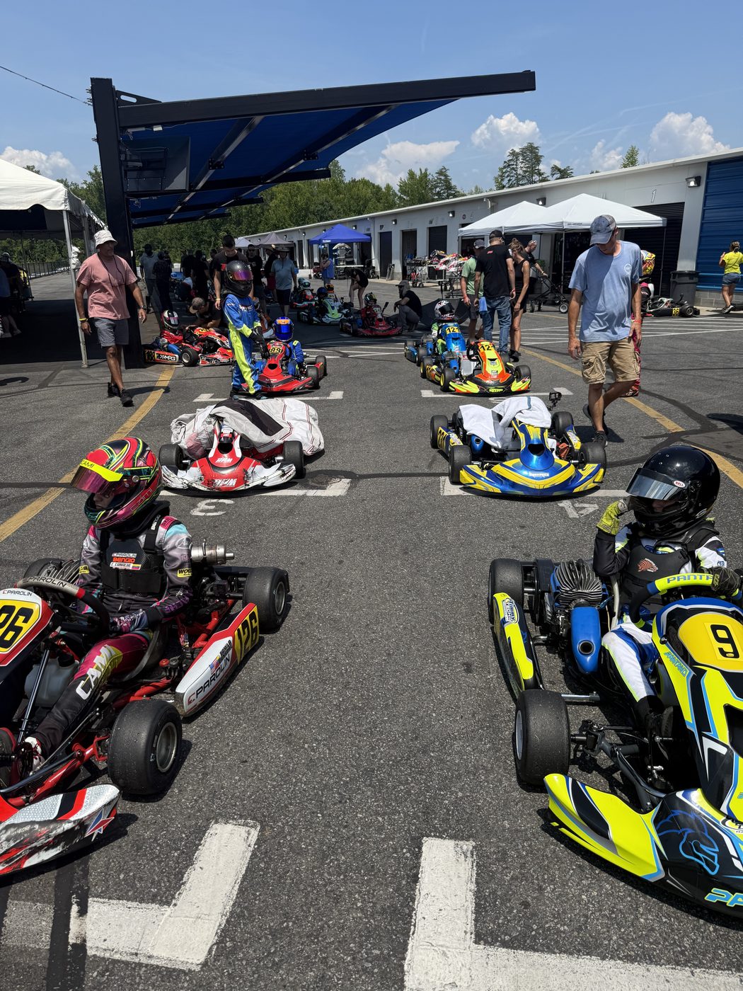 Karts lined up on the starting grid in the pit lane
