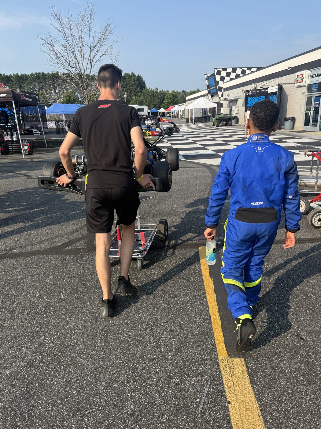 Kaz and the crew walking back from the grid after the session