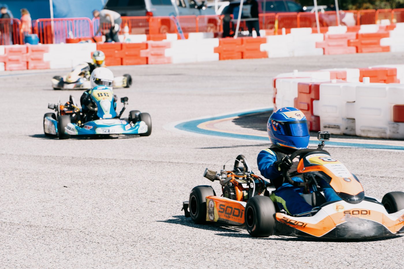 Kaz leading a pack of karts through a corner